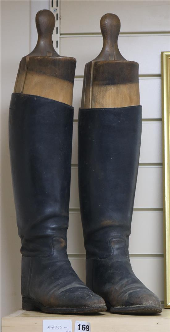 A pair of leather riding boots with stretchers